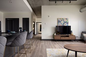 A modern living room with a grey sofa and a wooden coffee table.